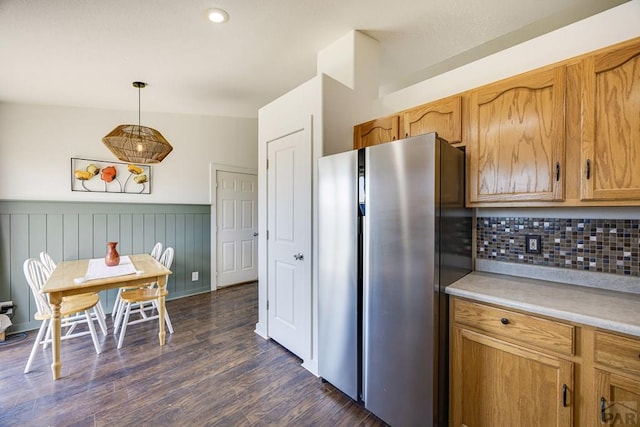 1085 E Blackstone Dr, Pueblo West, CO 81007 - kitchen featuring freestanding refrigerator, decorative backsplash, a wainscoted wall, light countertops, and dark wood-style floors