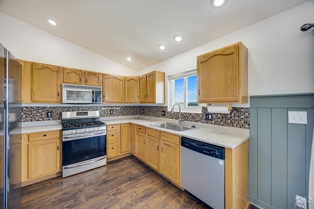 1085 E Blackstone Dr, Pueblo West, CO 81007 - kitchen featuring appliances with stainless steel finishes, lofted ceiling, backsplash, light countertops, and dark wood-style flooring