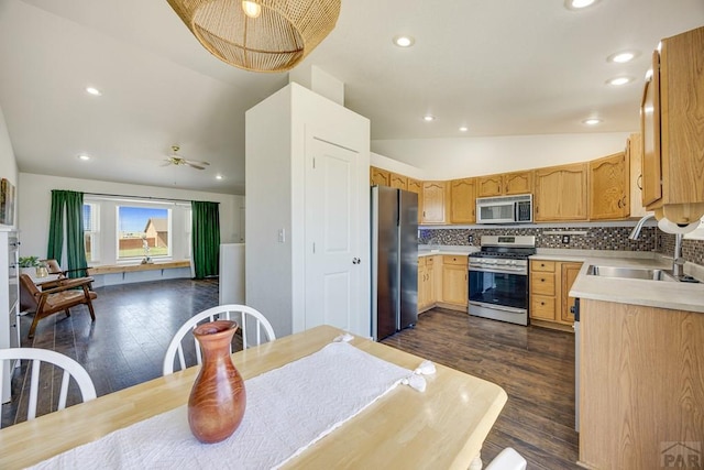 1085 E Blackstone Dr, Pueblo West, CO 81007 - kitchen featuring stainless steel appliances, dark wood-style floors, light countertops, decorative backsplash, and recessed lighting