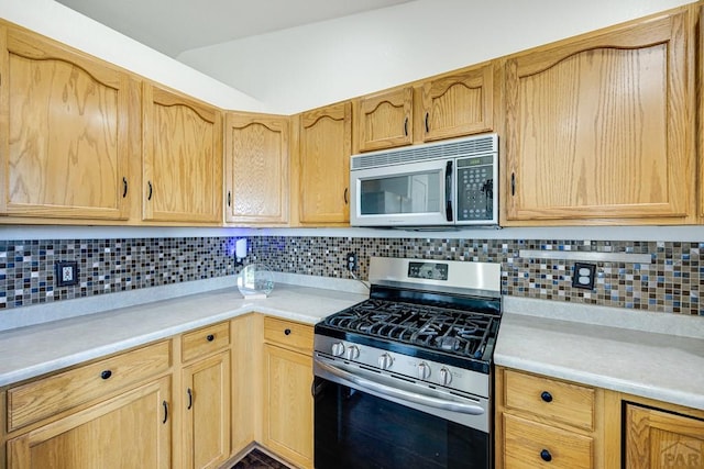 1085 E Blackstone Dr, Pueblo West, CO 81007 - kitchen featuring appliances with stainless steel finishes, light countertops, backsplash, and light brown cabinetry