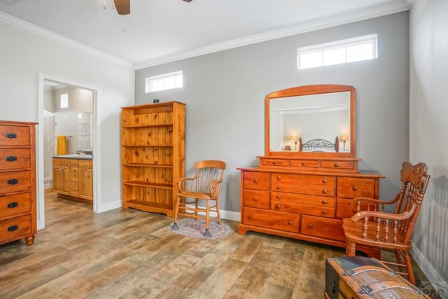 sitting room with a ceiling fan, wood finished floors, baseboards, and ornamental molding