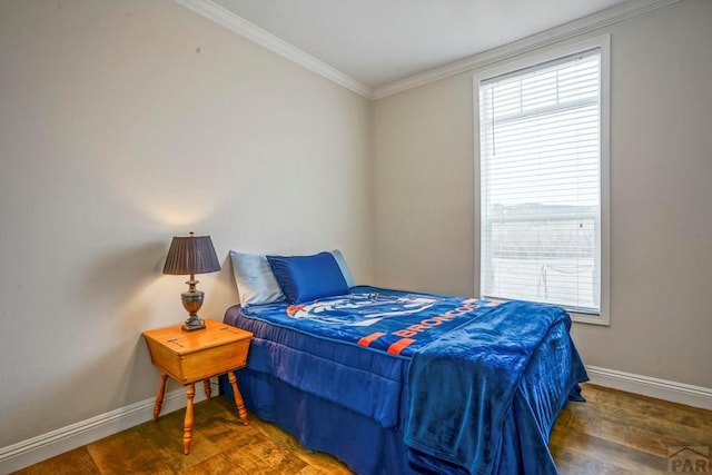 bedroom featuring wood finished floors, baseboards, and ornamental molding