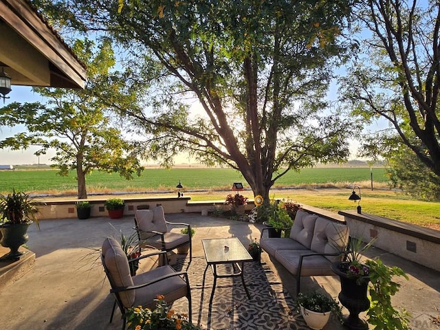 view of patio / terrace with a rural view and an outdoor hangout area