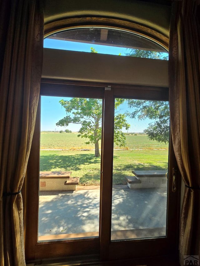doorway to outside featuring a rural view
