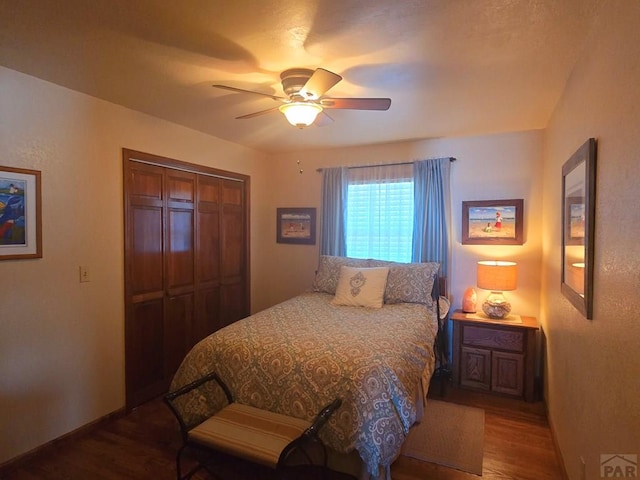 bedroom with a ceiling fan, a closet, baseboards, and wood finished floors