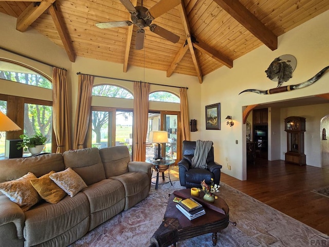 living area featuring arched walkways, high vaulted ceiling, dark wood-type flooring, wood ceiling, and beamed ceiling