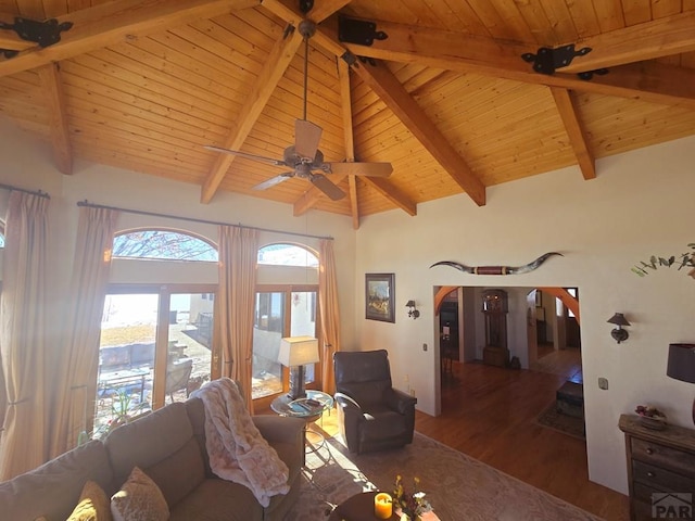 living area with arched walkways, wooden ceiling, and dark wood finished floors