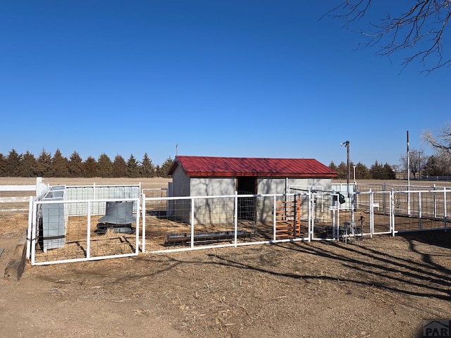 view of horse barn featuring a rural view