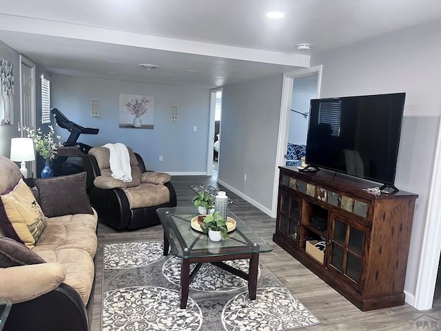 living area with light wood finished floors and baseboards