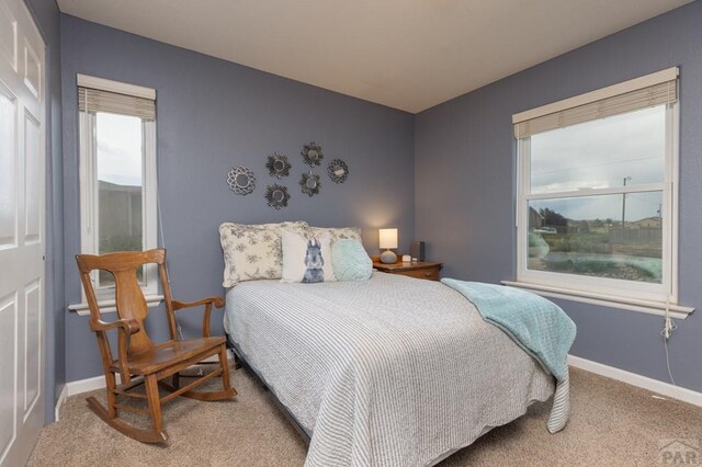 carpeted bedroom featuring baseboards