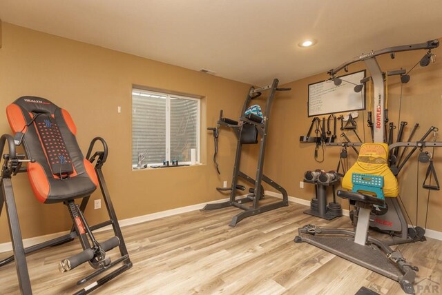 exercise room featuring light wood-type flooring, visible vents, baseboards, and recessed lighting