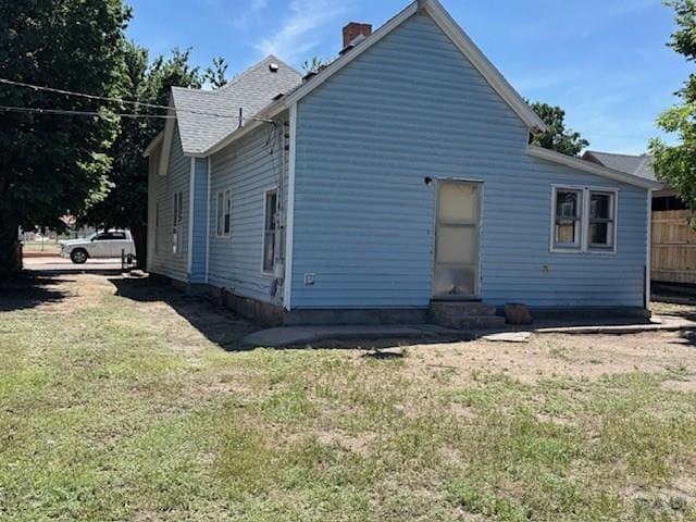 605 E 8th St, La Junta, CO 81050 - rear view of house with entry steps and a chimney