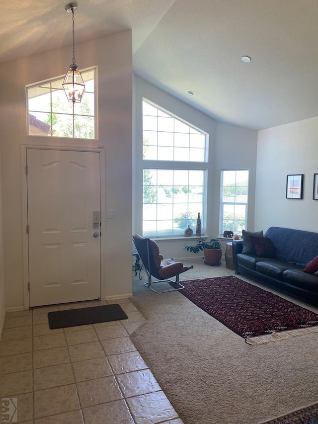 carpeted entrance foyer featuring a high ceiling