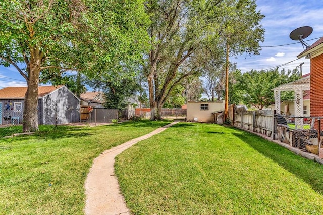 view of yard with an outbuilding and a fenced backyard