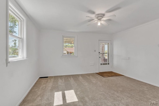 unfurnished room with carpet, baseboards, and ceiling fan