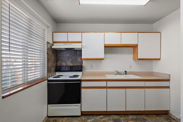 kitchen with under cabinet range hood, a sink, white cabinetry, light countertops, and white range with electric stovetop