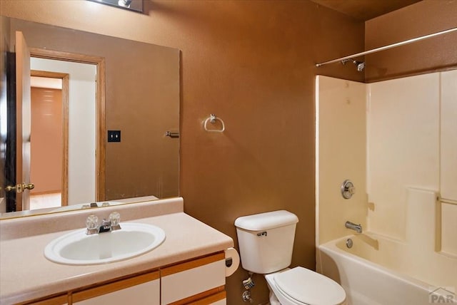 bathroom featuring toilet, shower / bathtub combination, and vanity