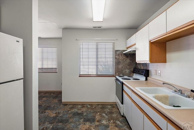 kitchen with light countertops, white cabinetry, a sink, white appliances, and under cabinet range hood