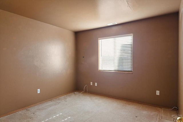 empty room featuring visible vents and light carpet