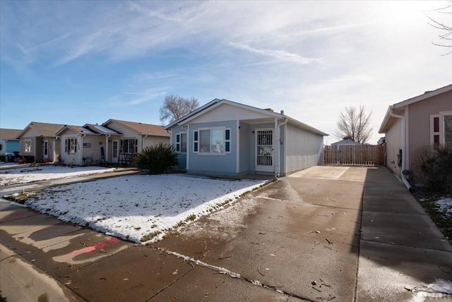 single story home with fence and a residential view