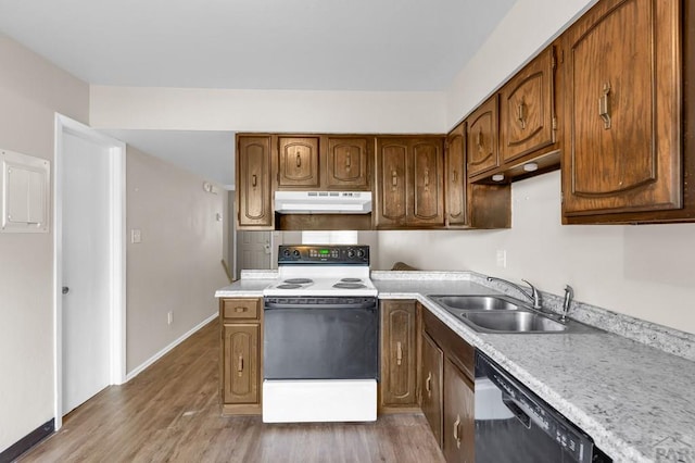 25 Royal Crest Dr Unit A, B, C, D, Pueblo, CO 81005 - kitchen featuring white electric range, under cabinet range hood, black dishwasher, a sink, and light wood finished floors