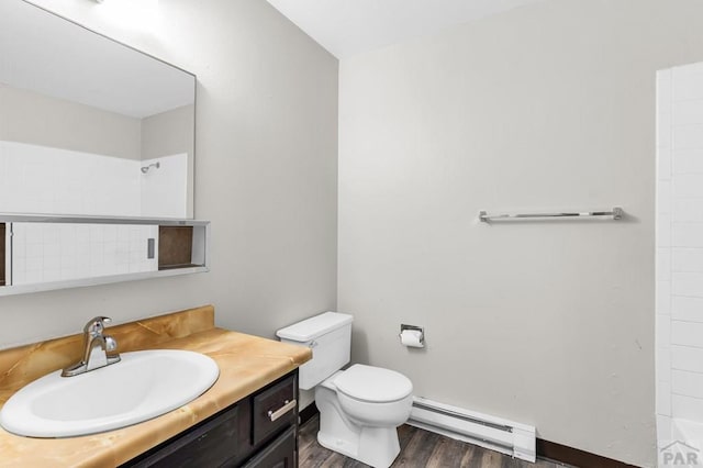 25 Royal Crest Dr Unit A, B, C, D, Pueblo, CO 81005 - bathroom with a baseboard radiator, vanity, wood finished floors, toilet, and a shower