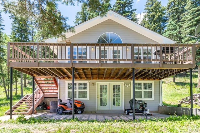 back of property with stairs, a patio, and a wooden deck