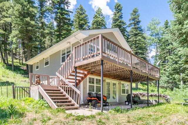 rear view of property with stairs, a patio, and a wooden deck