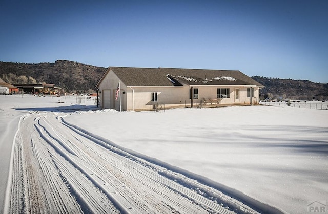 view of front of home with a mountain view and stucco siding