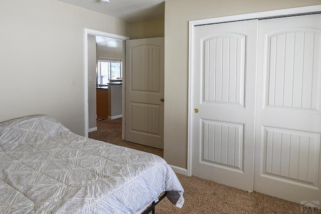 carpeted bedroom with a closet