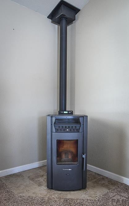 details with a wood stove and baseboards