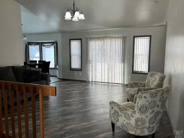 interior space with dark wood-style floors, a chandelier, and baseboards