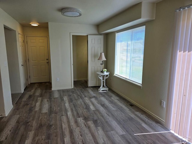 unfurnished bedroom featuring baseboards and wood finished floors