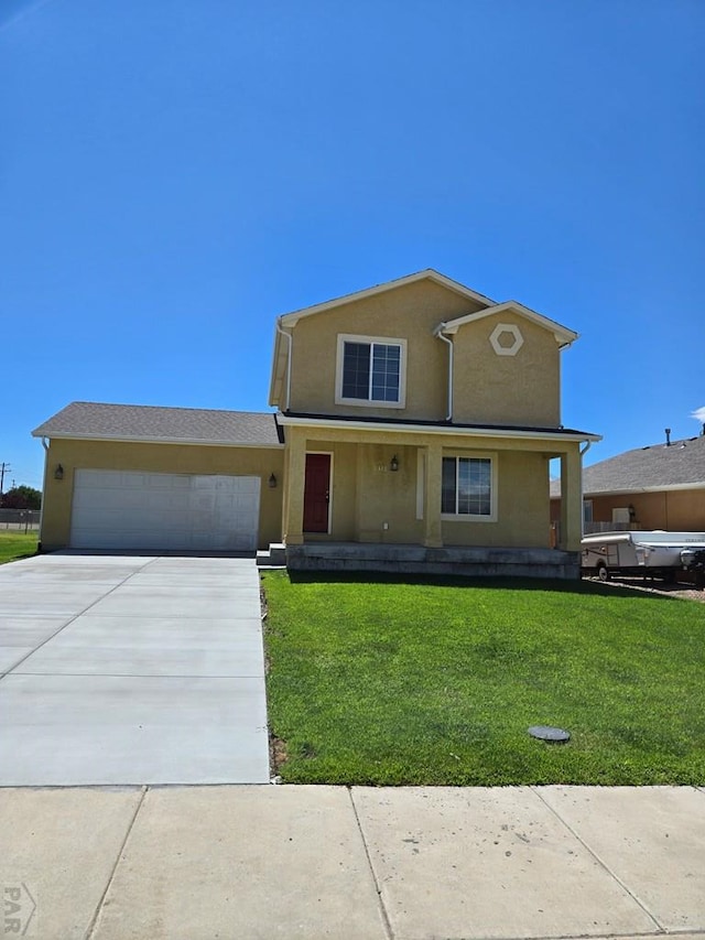 traditional-style house featuring a garage, driveway, a front lawn, and stucco siding