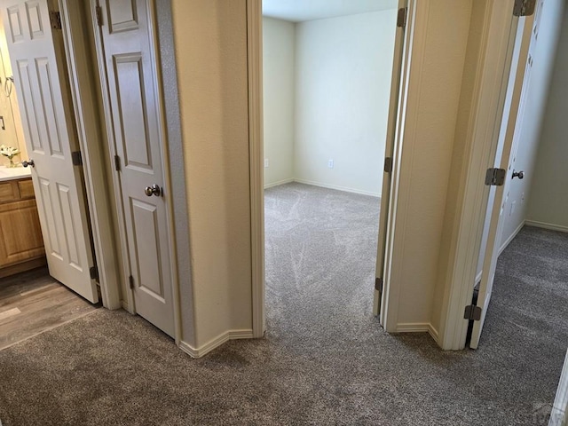 hall with carpet flooring and baseboards