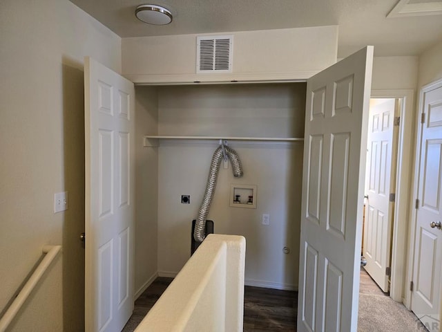 corridor with baseboards, visible vents, dark wood finished floors, and an upstairs landing