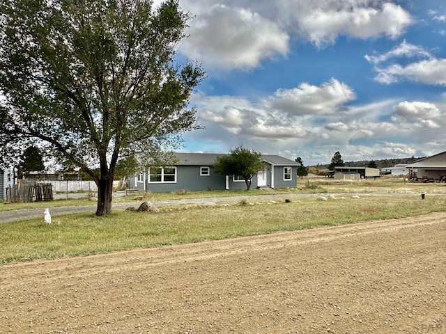 ranch-style home with fence