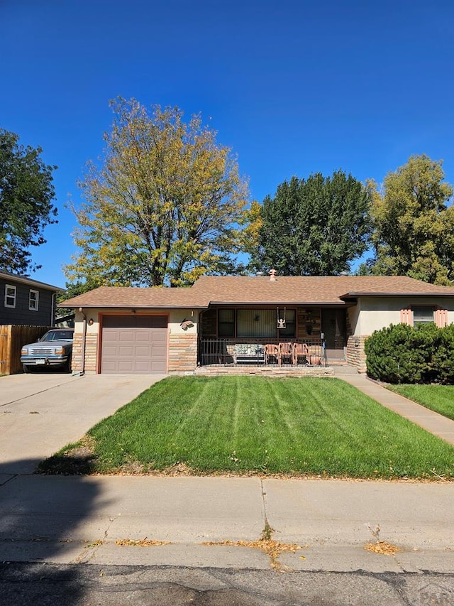 ranch-style home featuring concrete driveway, a front lawn, an attached garage, and brick siding