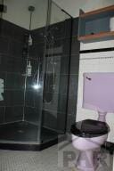 full bath with a stall shower and toilet