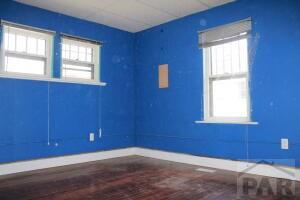 empty room with baseboards and wood finished floors