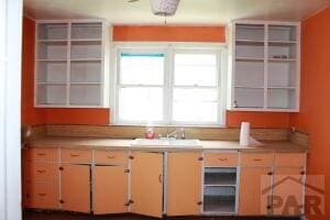 kitchen featuring light countertops and a sink