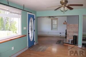 foyer entrance with a ceiling fan and wood finished floors