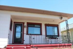 view of exterior entry featuring a porch