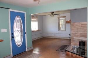 entrance foyer featuring ceiling fan, baseboards, and wood finished floors