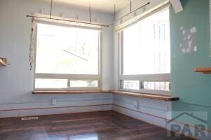 unfurnished dining area with dark wood-style floors