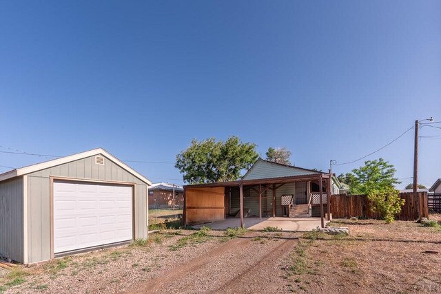 318 E Goddard Ave, Trinidad, CO 81082 - view of front facade with a garage, dirt driveway, and an outdoor structure