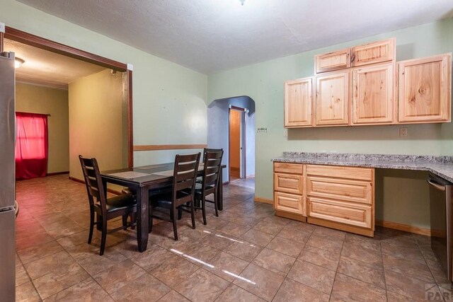 318 E Goddard Ave, Trinidad, CO 81082 - dining space featuring built in desk, baseboards, and a textured ceiling