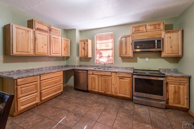 318 E Goddard Ave, Trinidad, CO 81082 - kitchen with appliances with stainless steel finishes, a sink, and light brown cabinetry