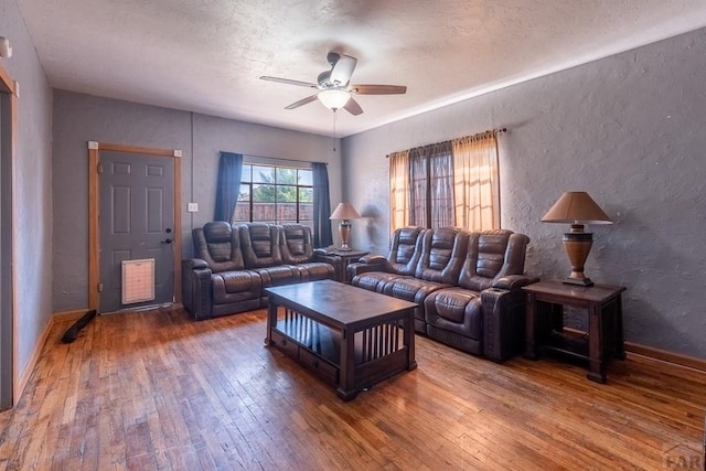 318 E Goddard Ave, Trinidad, CO 81082 - living area featuring a textured wall, hardwood / wood-style flooring, ceiling fan, a textured ceiling, and baseboards