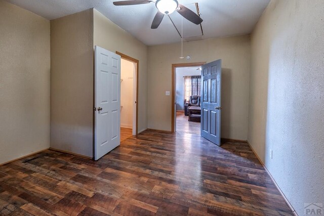 318 E Goddard Ave, Trinidad, CO 81082 - unfurnished room with ceiling fan, dark wood-style flooring, a textured wall, and attic access